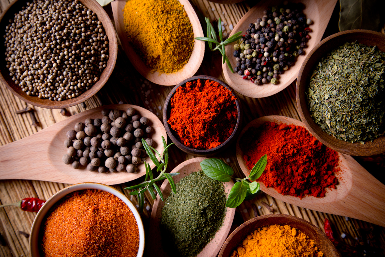 Assorted spices on wooden background