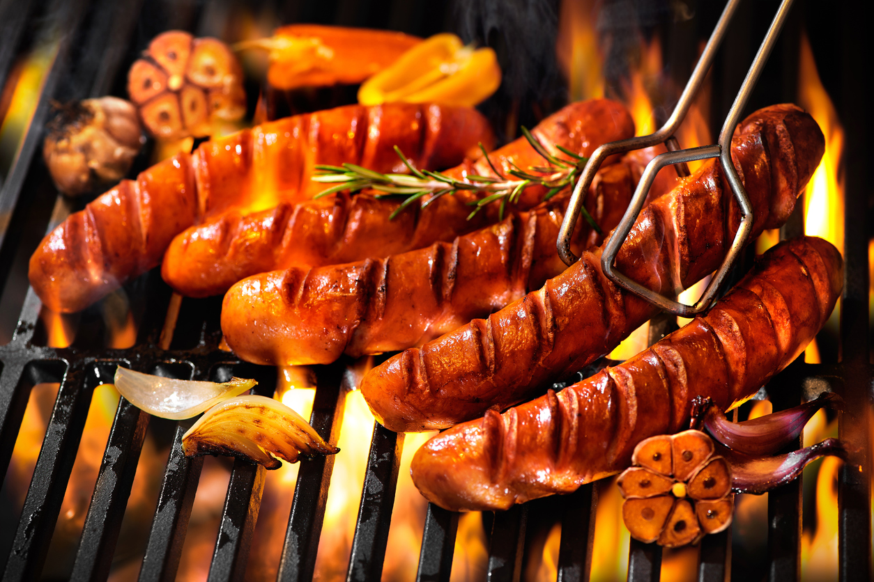 Grilled sausage on the flaming grill